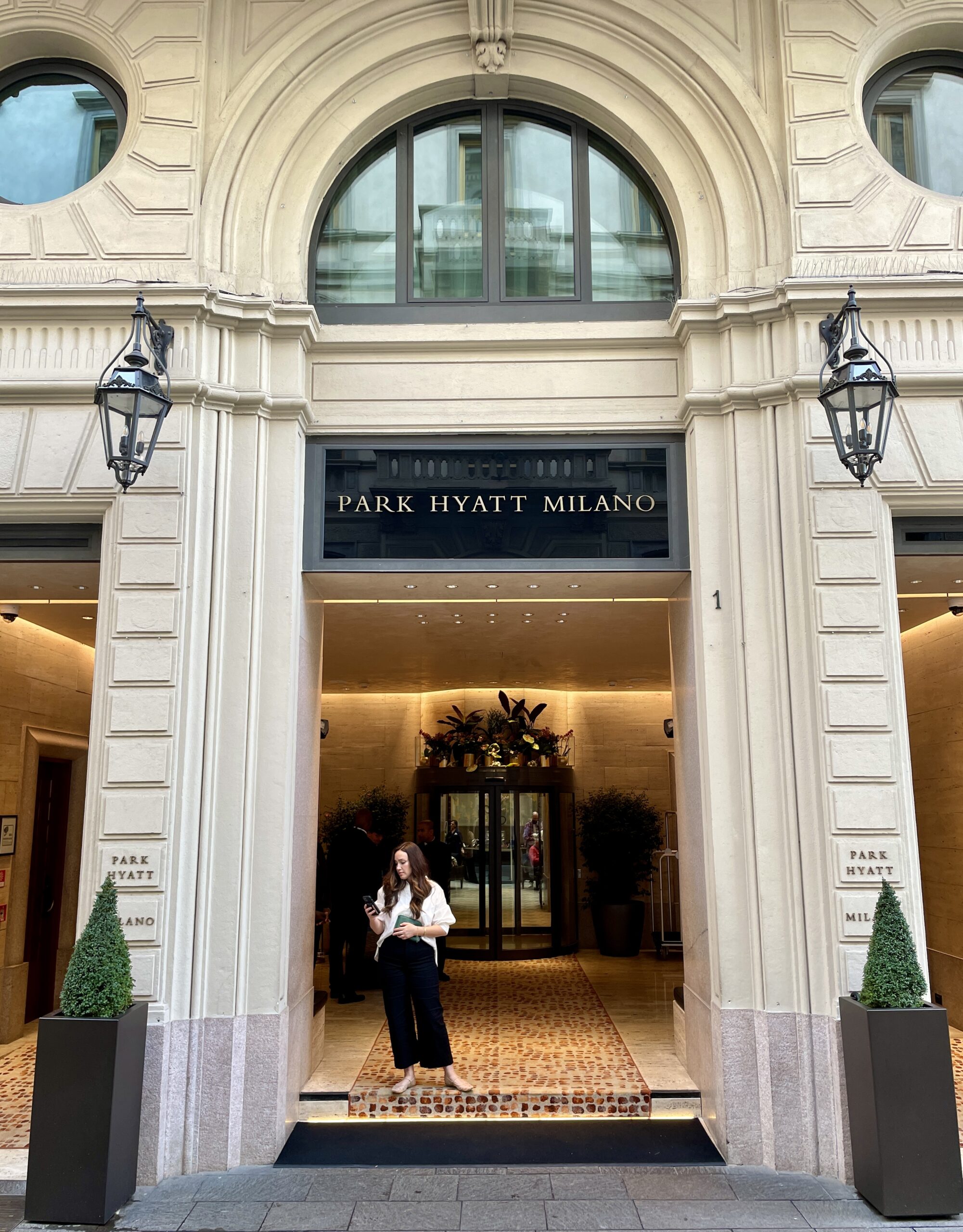 woman looking at phone at park hyatt milano hotel